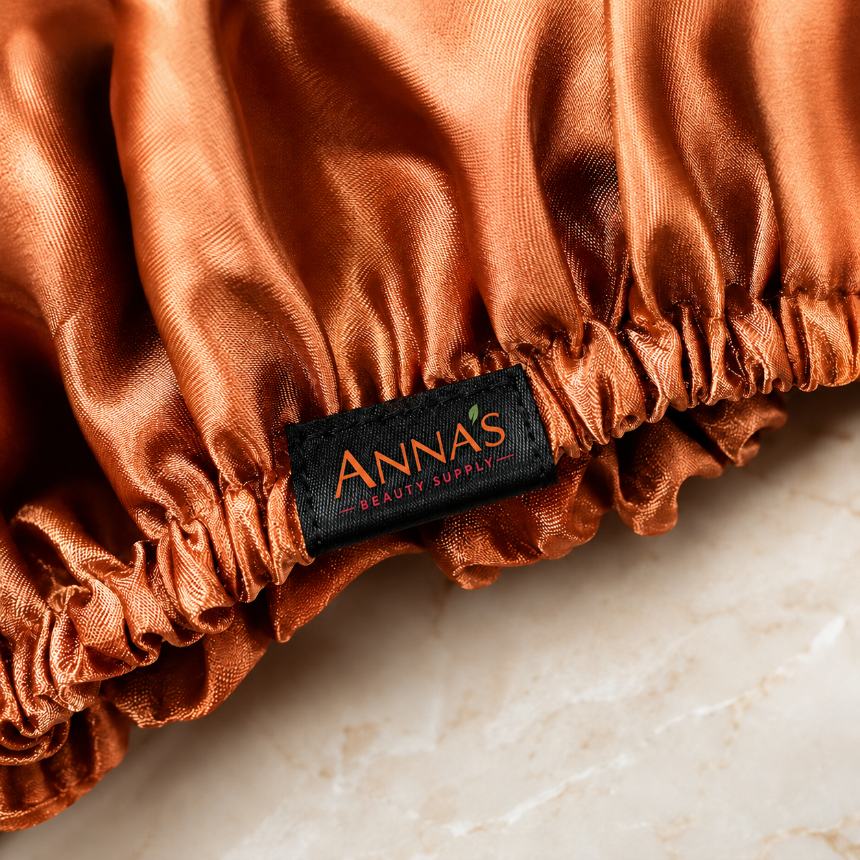 Anna's Beauty Supply woven label detail on satin sleep bonnet